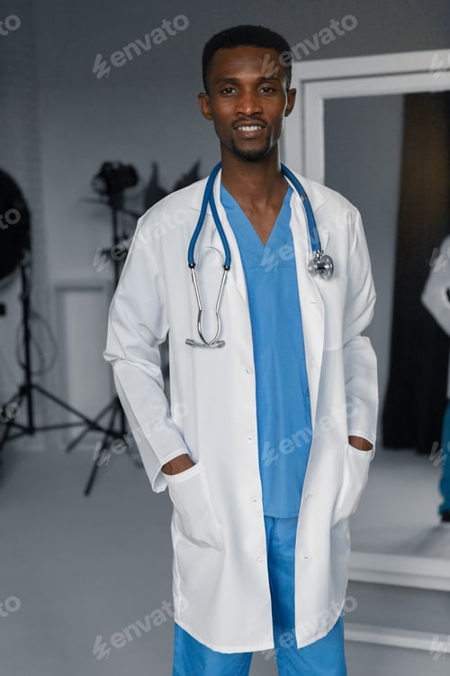 Preview: Handsome Guy Doctor In White Lab Coat With Stethoscope On White Background