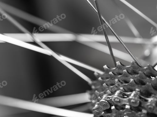 Preview: Details of a bicycle chain and sprockets with blurry spokes