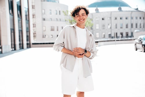Preview: Attractive man with curly hairstyle outdoors