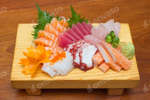 Preview: Sashimi (japanese food). Sliced raw seafood on wooden plate.