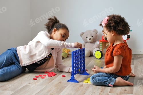 Preview: Sibling girls playing a game of four in a row