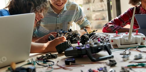 Preview: School kids boys helping building robotic car learning together at STEM class.
