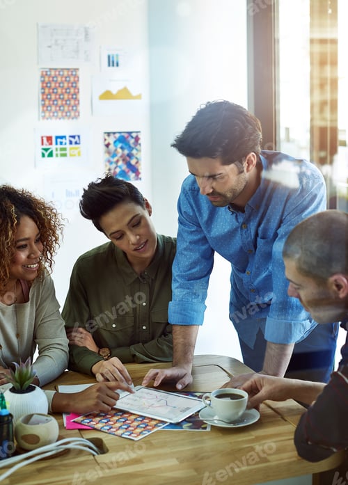 Preview: Cropped shot of a group of coworkers discussing something on a tablet