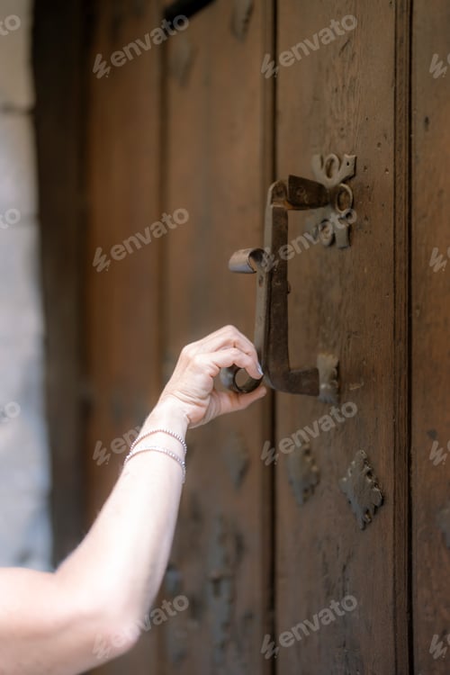 Preview: one-handed woman clutching an antique door knocker