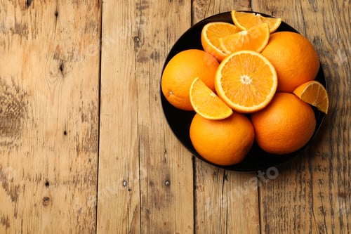 Preview: Fresh ripe oranges on wooden table, top view. Space for text