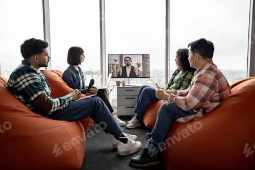 Preview: Employees making video call on display in office interior