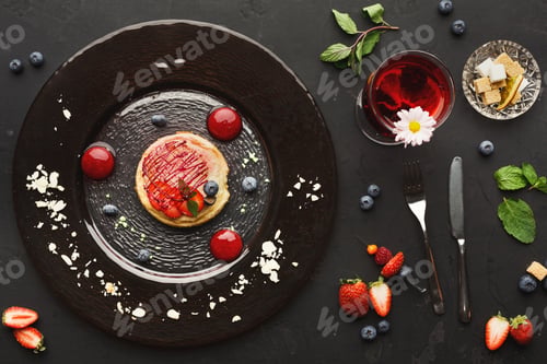 Preview: Lemon cheesecake with berry spheres served at modern restaurant