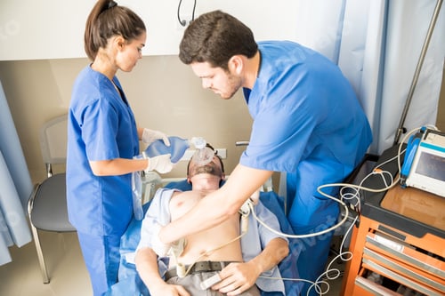 Preview: Doctors performing defibrillation on a patient