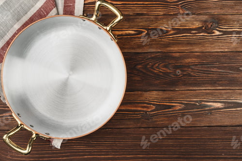 Preview: Copper pot with chekered tablecloth on wooden table