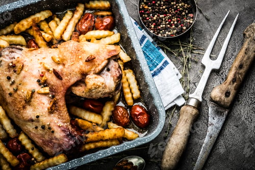 Preview: Turkey wing with french fries in baking tray top view