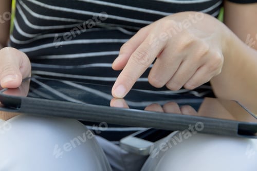 Preview: Woman using digital tablet