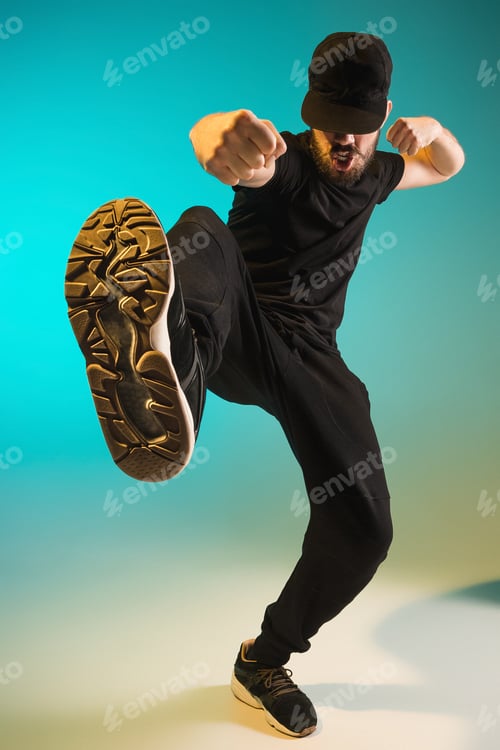 Preview: The Silhouette Of One Hip Hop Male Break Dancer Dancing On Colorful Background