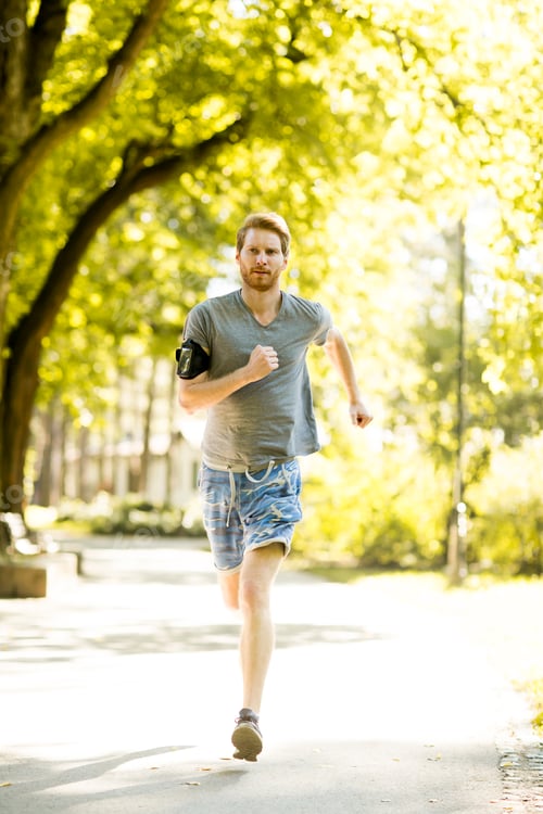 Preview: Young man running in the autumn park