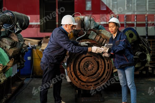 Preview: Maintenance manager and engineer checking part large engine supercharger prepare for overhaul repair