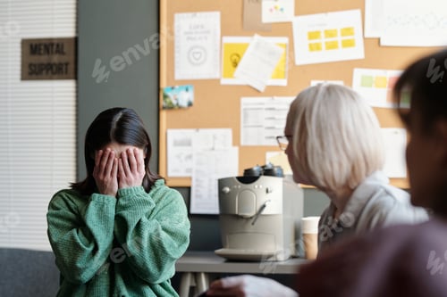 Preview: Crying woman covering face with hands