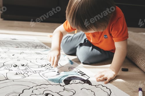 Preview: Cute little boy drawing with felt pens on floor at home. Early education concept.