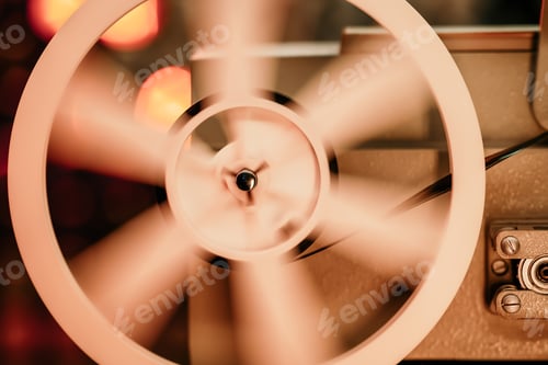 Preview: 8mm movie projector playing at theater. White reel or can with tape film turning. Analog player.