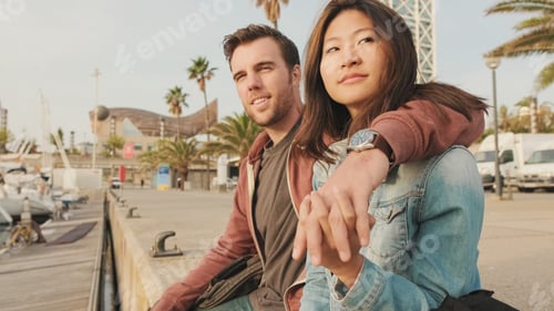 Preview: Close-up of young happy couple sitting in seaport