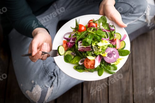 Preview: Fresh salad in hands view from above