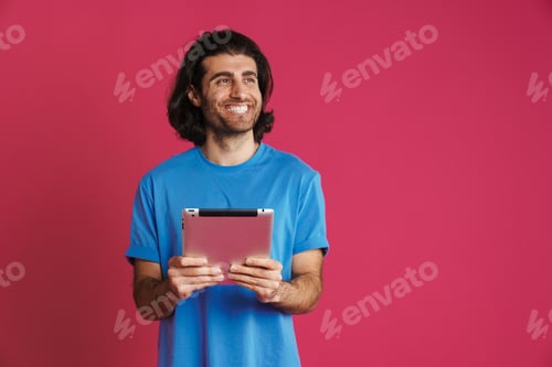 Preview: Unshaven white man smiling while posing with tablet computer