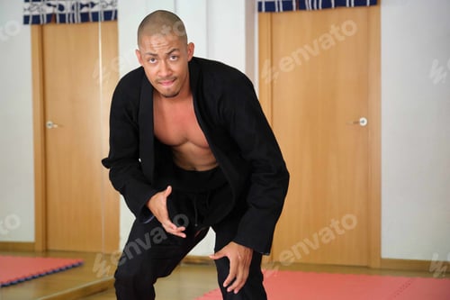 Preview: Brazilian Jiu-Jitsu teacher at the Academy looking at camera.