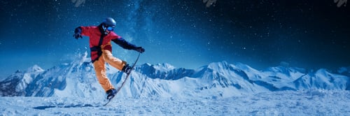 Preview: Snowboarder Performing Trick on Mountain Wide Banner