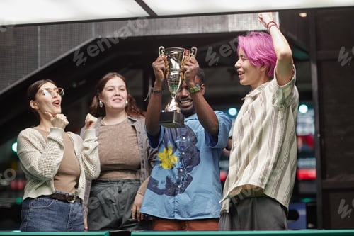 Preview: Celebrating Victory Holding Trophy in Recreational Center