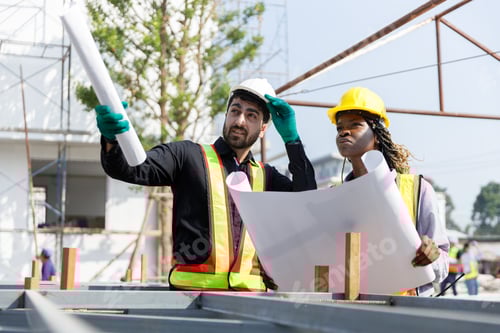 Preview: Construction civil engineer man and woman African American checking quality of work in construction