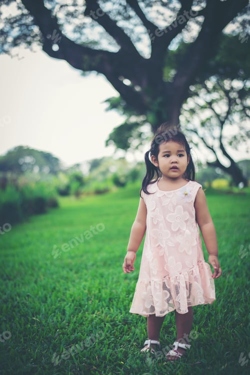 Preview: Smiling young girl standing in the park, happy time