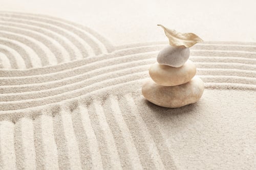 Preview: Stacked zen marble stones sand background in mindfulness concept