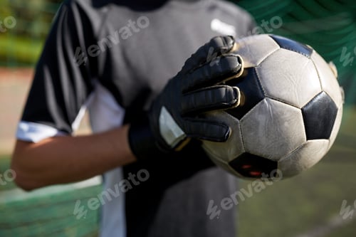 Preview: close up of goalkeeper with ball playing football