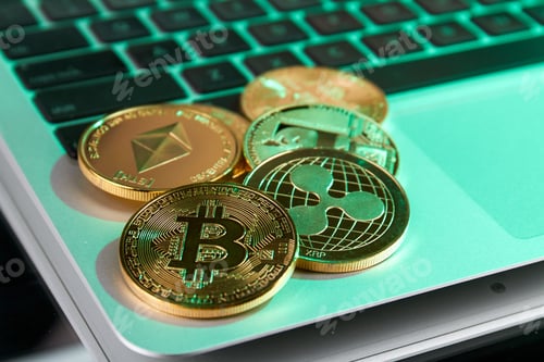 Preview: Golden cryptocurrency coins on the laptop close-up.