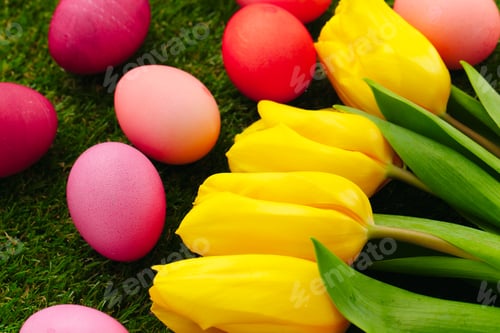 Preview: Colored Easter eggs on grass decorated with flowers