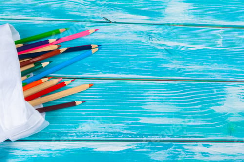 Preview: Colorful pencils on a bright blue wooden background