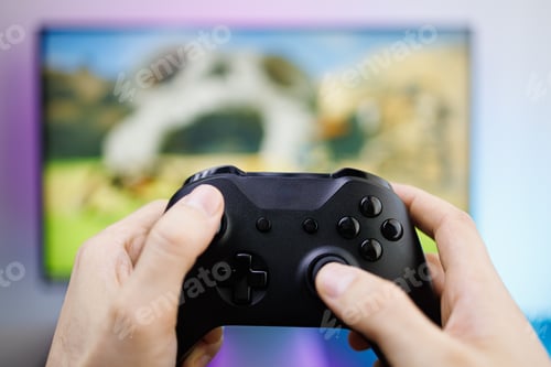 Preview: Pressing the sticks of a game gamepad in front of the monitor. Video game gamepad in hand