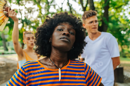 Preview: Portrait of an african american activist standing in nature.