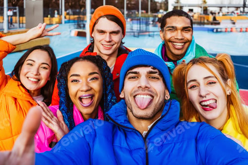 Preview: Multiracial group of young friends meeting outdoors in winter