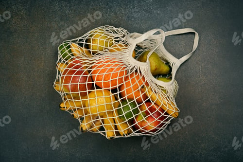 Preview: Assorted fresh fruits in string shopping bag