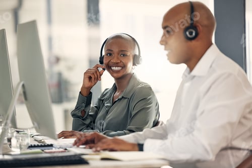 Preview: Portrait of happy young african american call centre telemarketing agent talking on a headset while