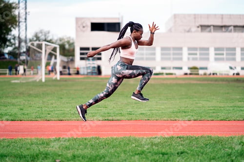 Preview: African-American athlete sprinter jumping. Sport