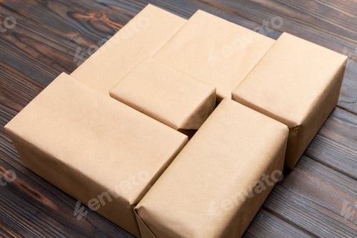 Preview: Brown mail package parcel blank for you design. Cardboard box on a dark wooden background