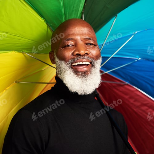 Preview: Im covered. Shot of a senior man posing with a colorful umbrella over his head.