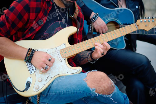 Preview: Musicians playing acoustic and electric guitars outdoors during a casual gathering