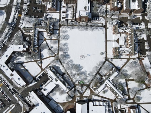 Preview: Aerial shot of the city with snow-capped houses and cars