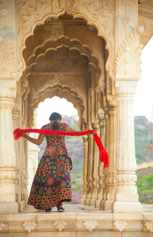 Preview: Indian woman standing between arches and Pillars.