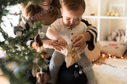 Preview: Playful Toddler and Mother with Christmas Gift