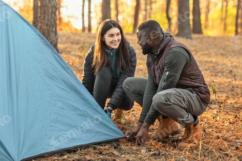 Preview: Man and woman making tent together, having conversation