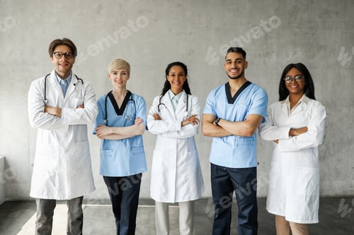 Preview: Multiracial medical team posing at clinic while having team-building