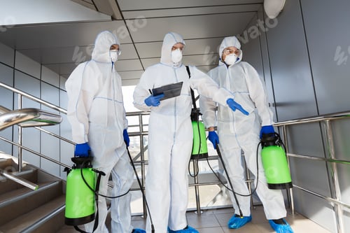 Preview: Men in protective suits deciding what to disinfect with spray