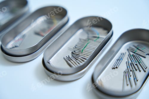 Preview: Photo of metal organizers with burs on background of table